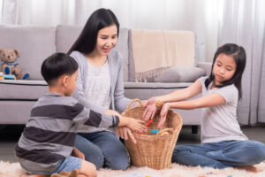 Happy family tidying up toys together